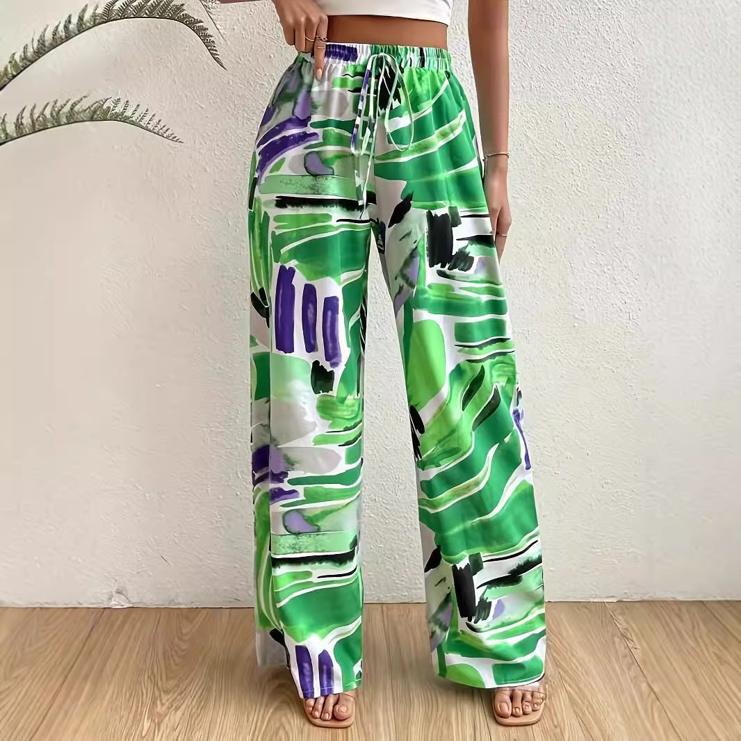 Elastic waist wide-leg pants by eprolo in green abstract print with purple and black accents