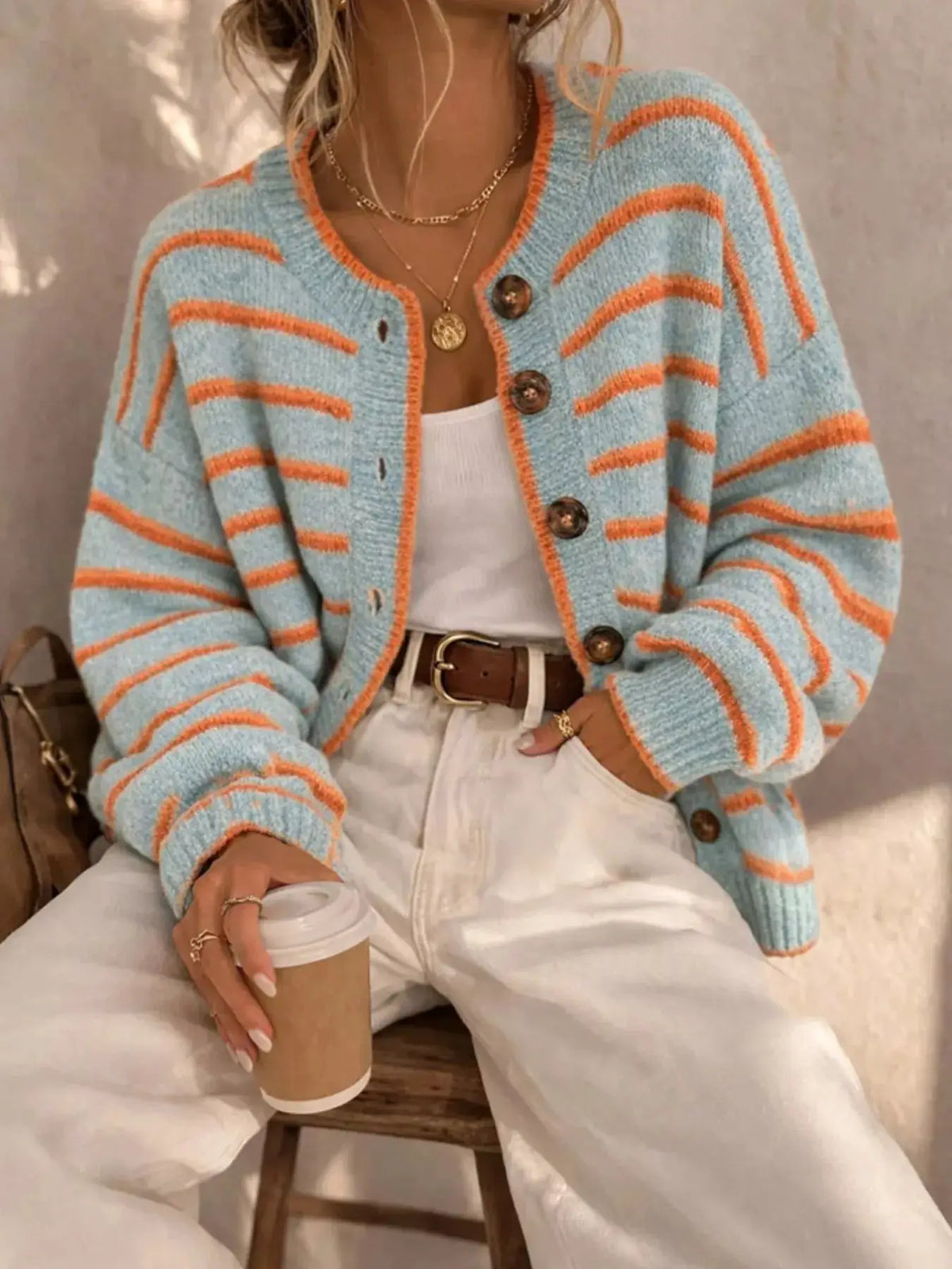 Striped Button-Down Knit Cardigan by Trendsi; pastel blue with orange stripes.