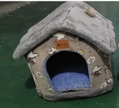 Foldable dog house and pet bed by AdTec with gray exterior and blue cushion inside.