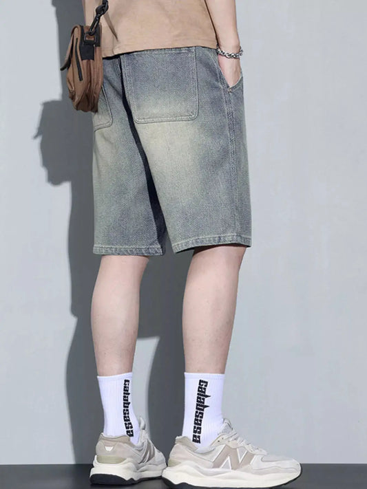 Men's vintage wash relaxed-fit denim shorts in light blue with knee-length cut and pocket details.