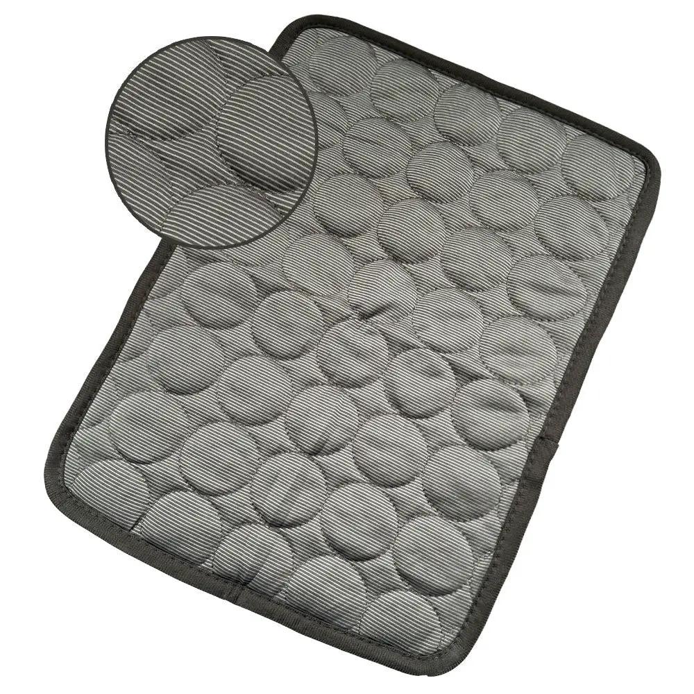 Dog cooling mat in grey quilted fabric with circular puffed pattern and dark edge
