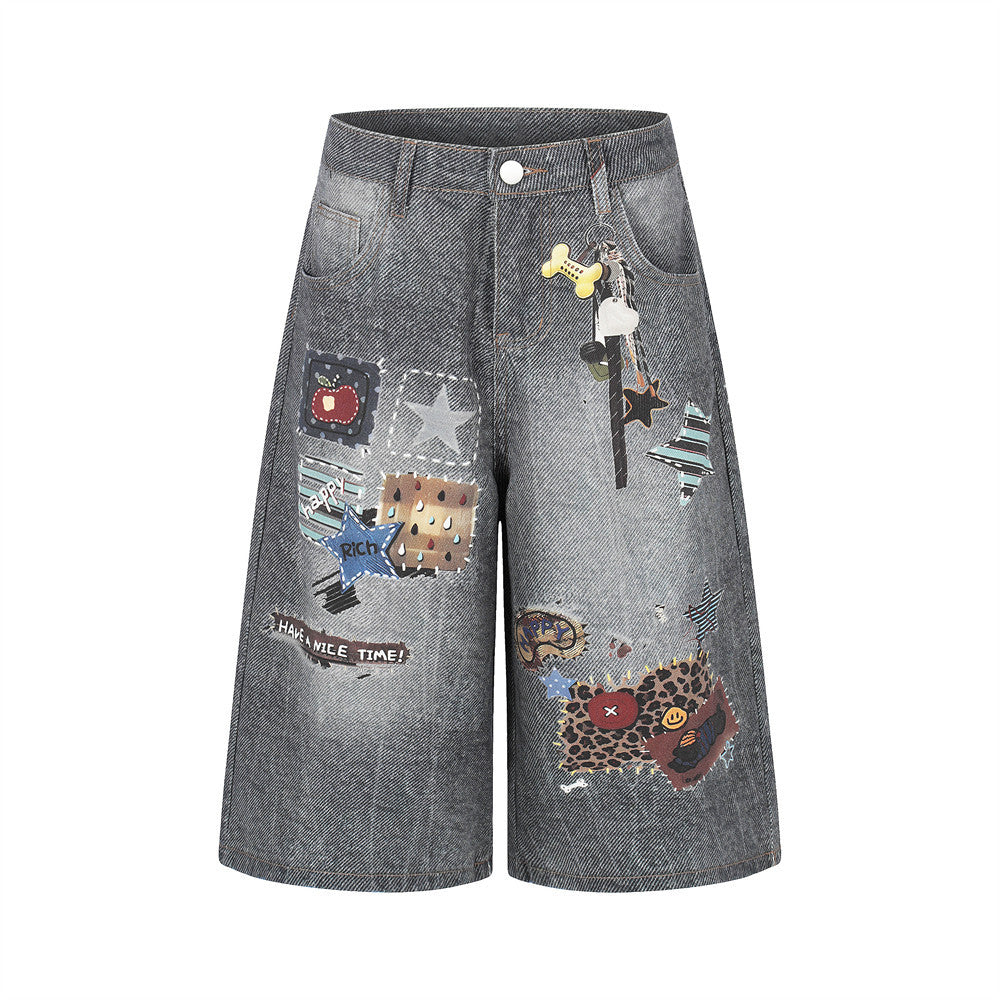 Denim patchwork shorts in gray-blue with colorful patches and distressed details.