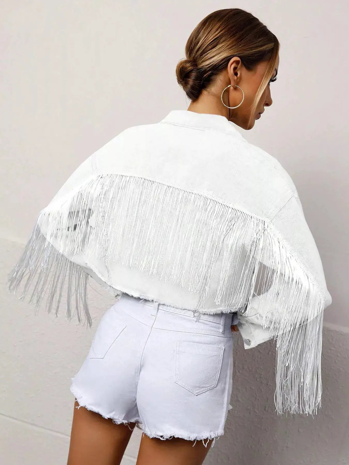 Fringed cropped denim trucker jacket by Trendsi in white with long fringe tassels