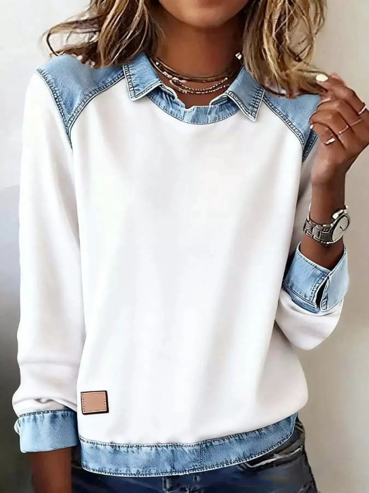 Plus-size white long-sleeve top with contrast denim trim overlay on collar, shoulders and cuffs.