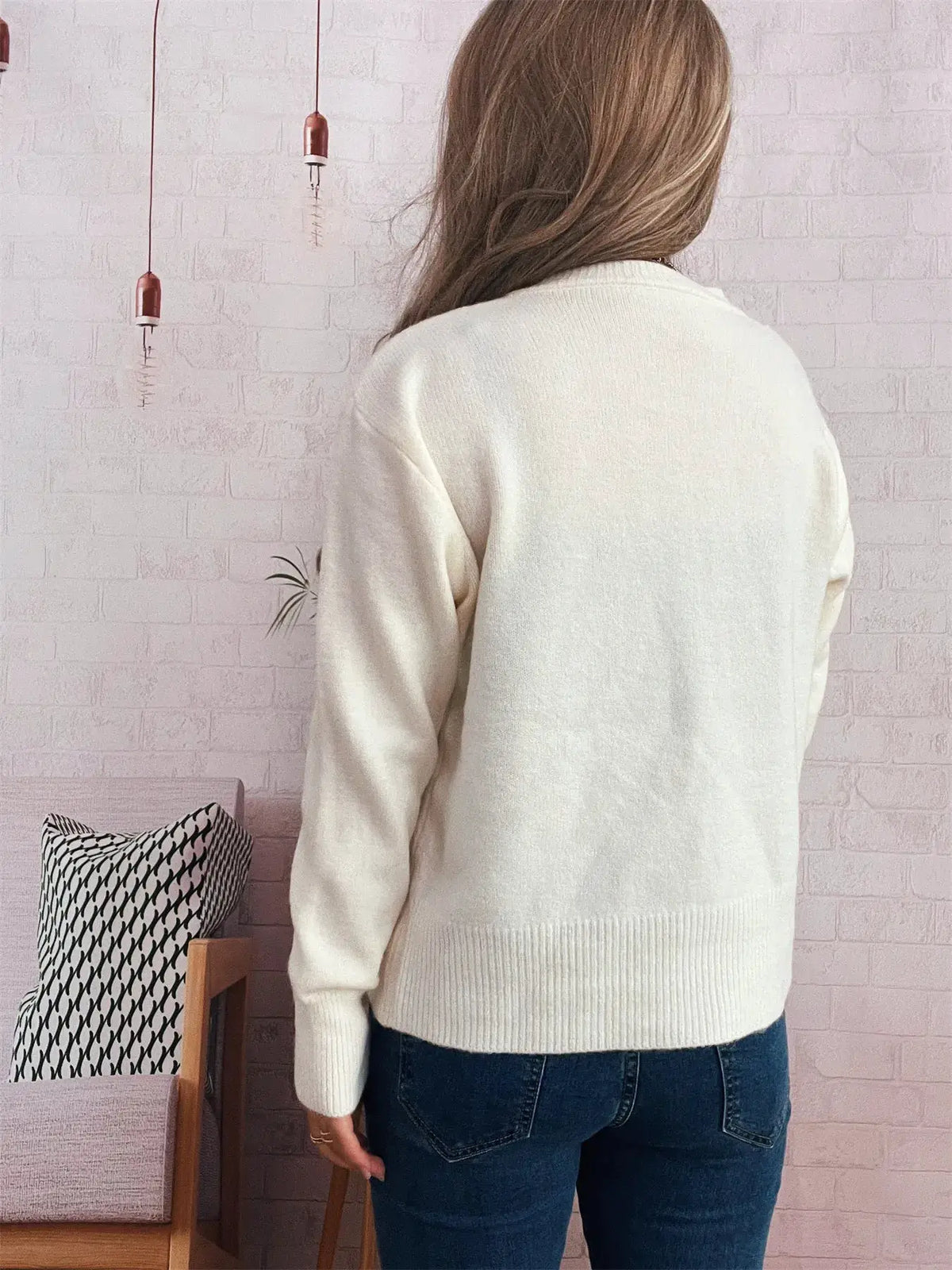 Cream ribbed knit cardigan hip-length back view with long sleeves.