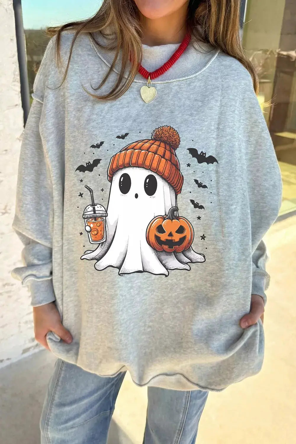 Reversible Halloween graphic mock-neck tunic sweatshirt in gray with a ghost in an orange knit hat, pumpkin and drink.