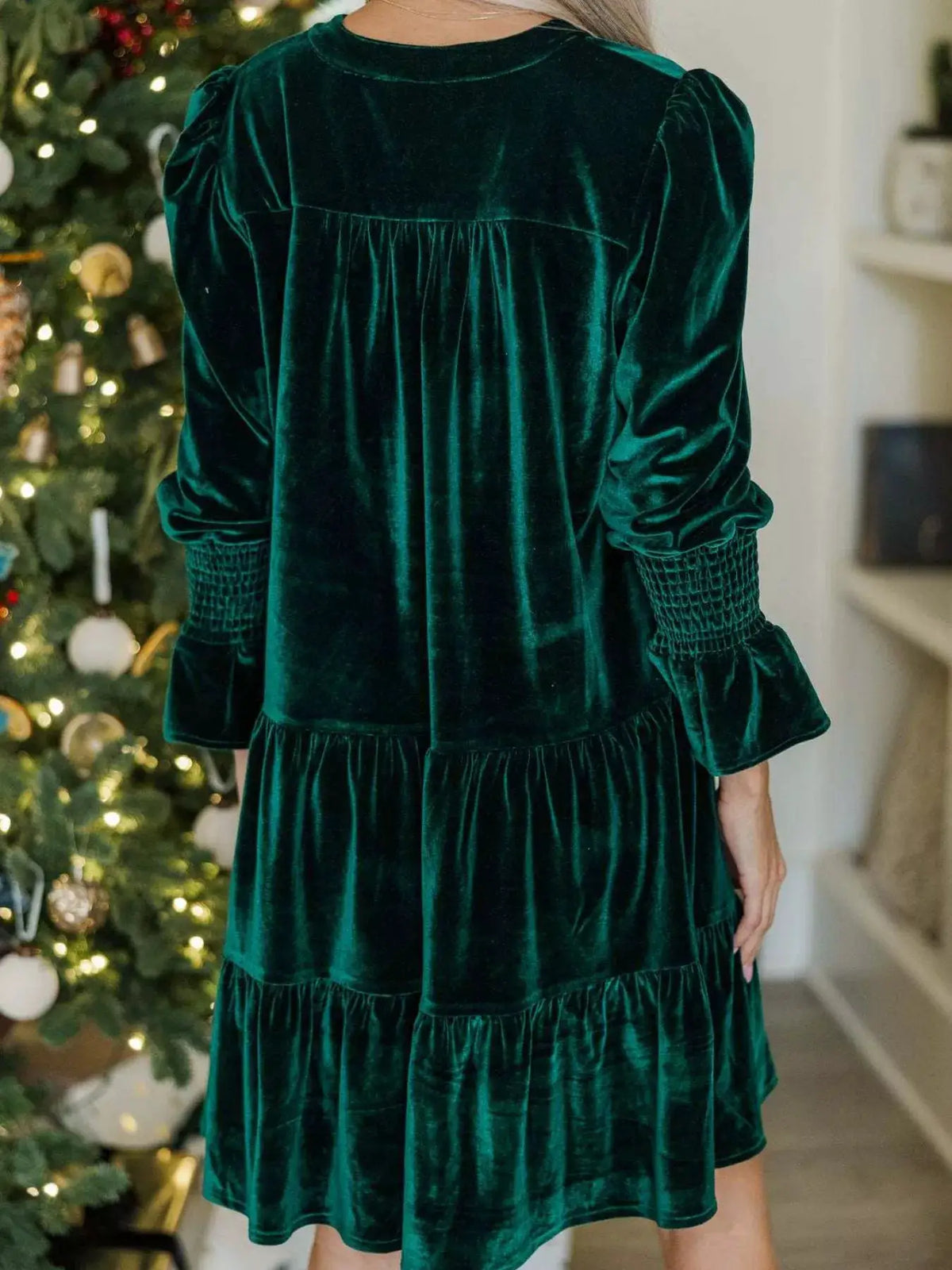 Velvet tiered notched mini dress in emerald green with puff sleeves and smocked cuffs