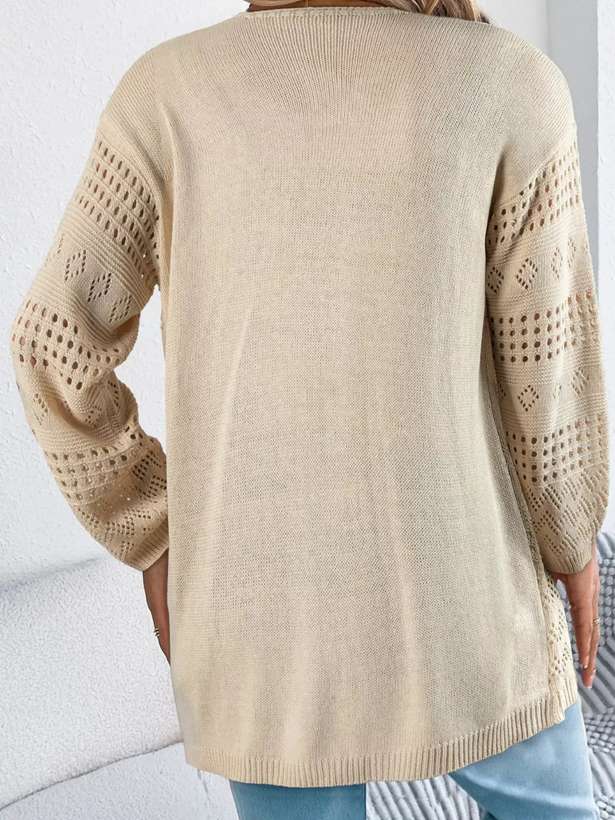 Hollowed knit open-front cardigan with perforated sleeves in beige by Trendsi