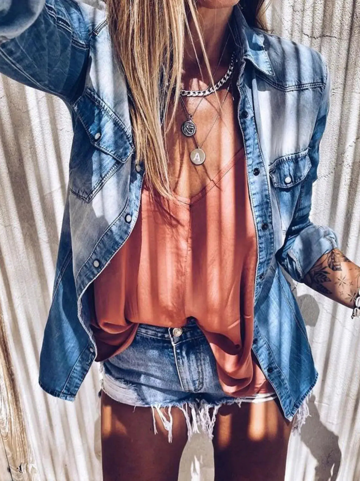 Vintage washed denim button-up shirt, blue, relaxed fit worn over a peach top with layered necklaces
