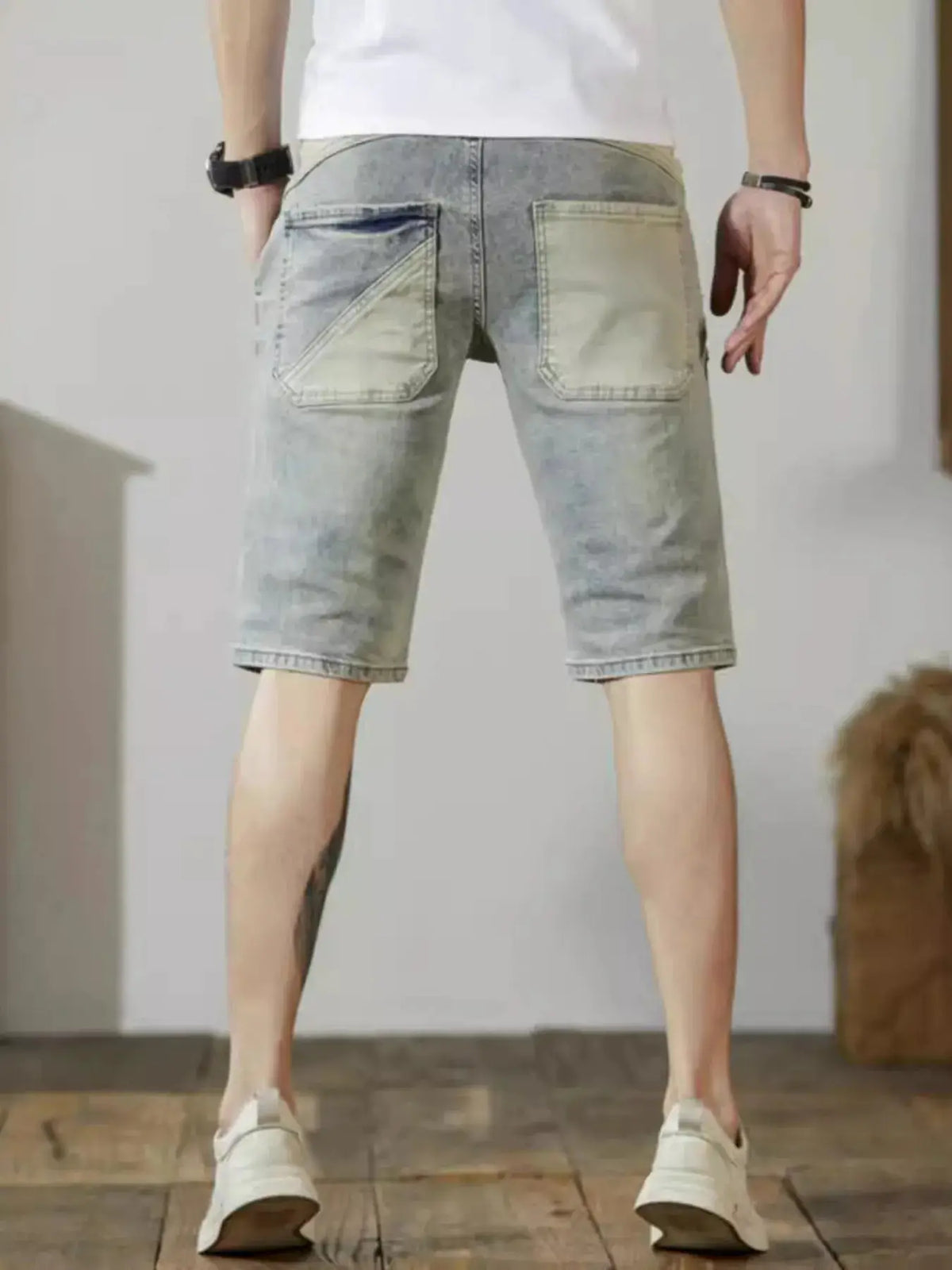 Men's relaxed stretch cotton denim shorts with distressed wash, light blue, back view