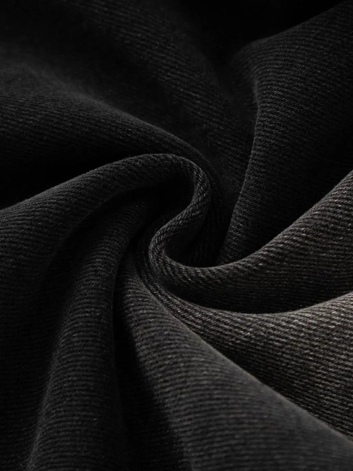Men's relaxed-fit washed denim stretch Bermuda shorts fabric close-up in black