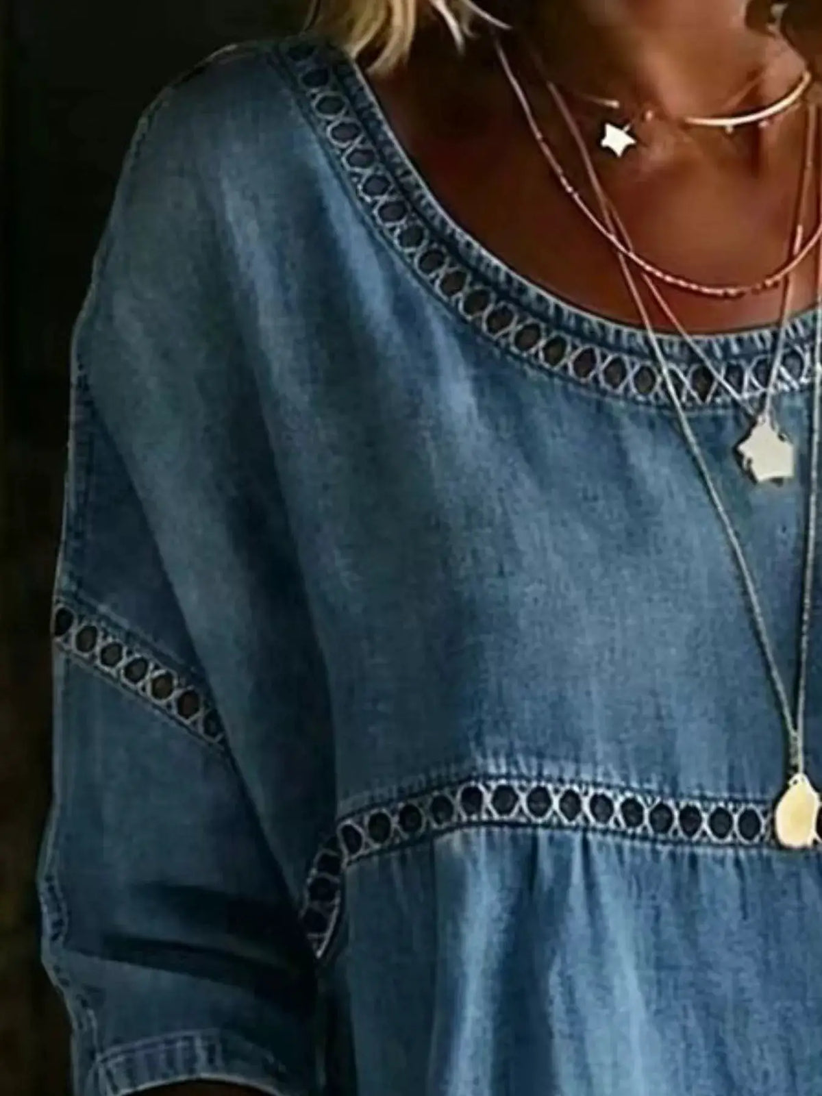 Plus-size hollow-out round-neck denim top with decorative circular cutout trim in blue