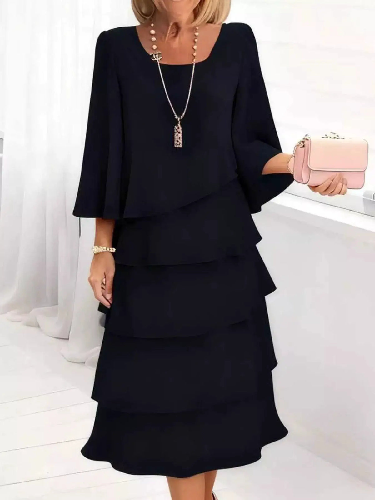 Full Size Ruffled Layered 3/4 Sleeve Dress Plus Size by Trendsi in black with pink clutch