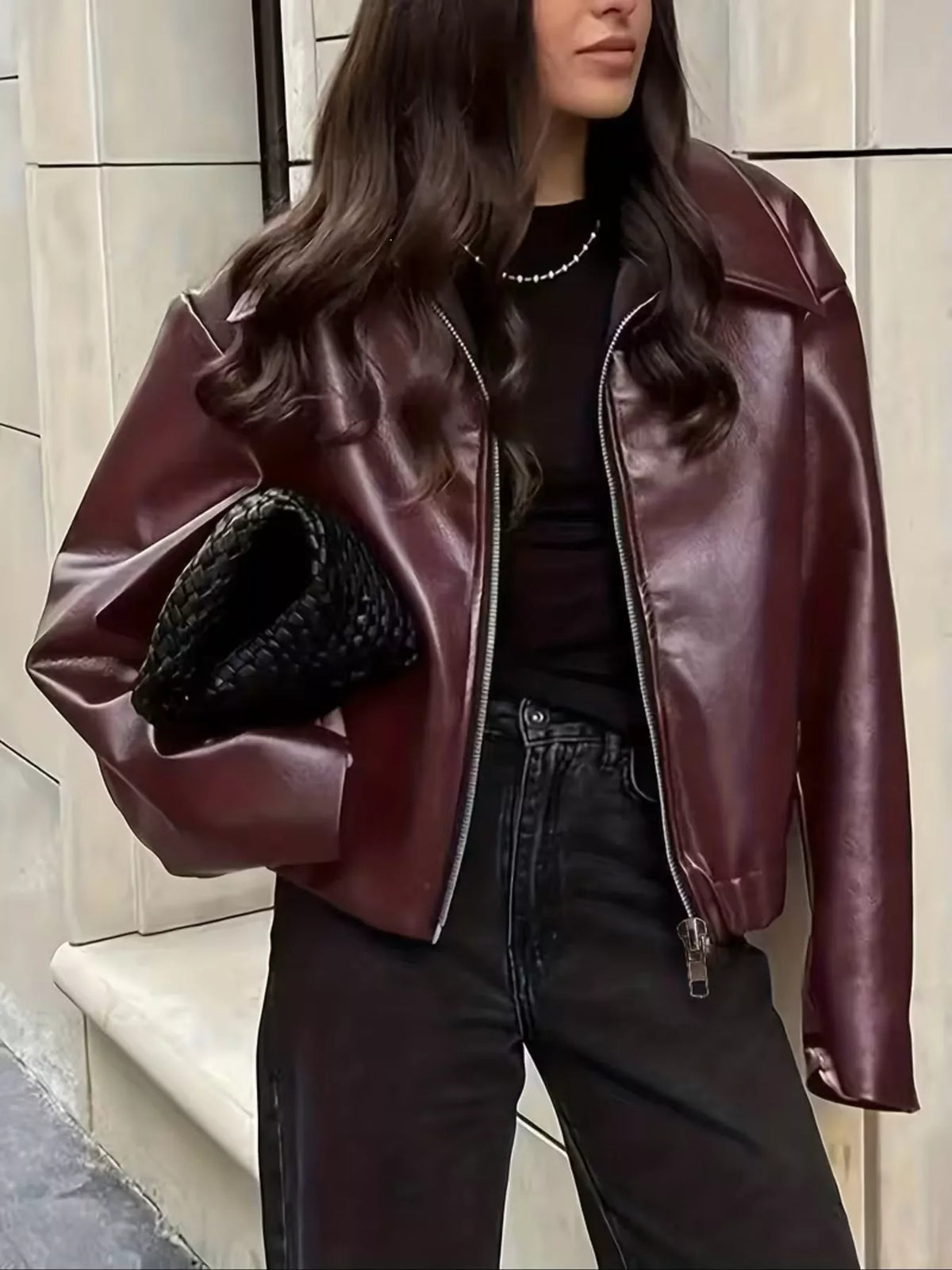 Oversized faux leather moto jacket in burgundy with full-zip front.