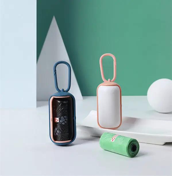 Poop bag dispenser duo by AdTec; portable units with blue and pink frames and roll of bags