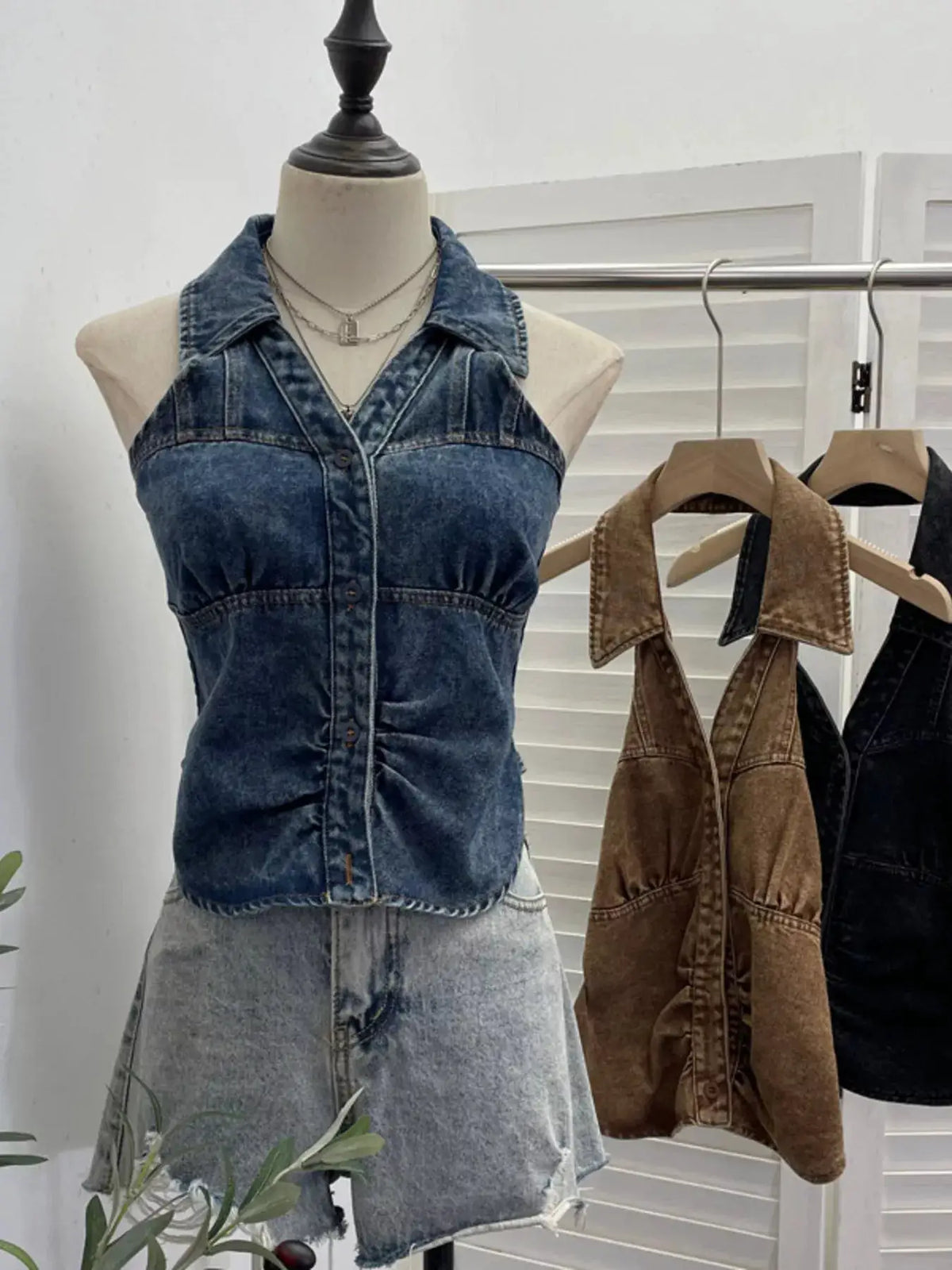 Premium textured smocked denim halter top; blue denim, sleeveless, front button-down on mannequin.