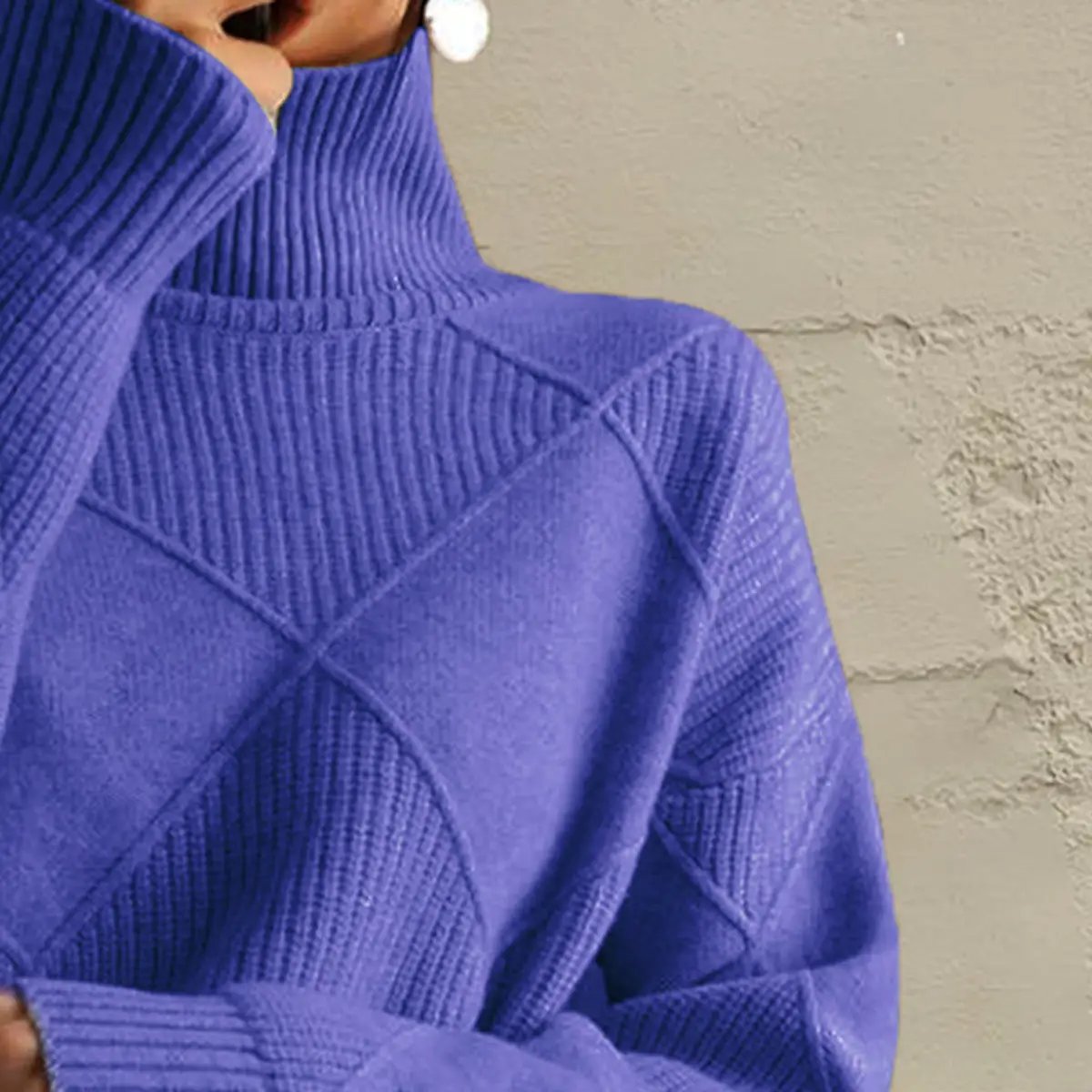 Blue geometric turtleneck long-sleeve stretch-knit sweater with visible panel seams and ribbed cuffs