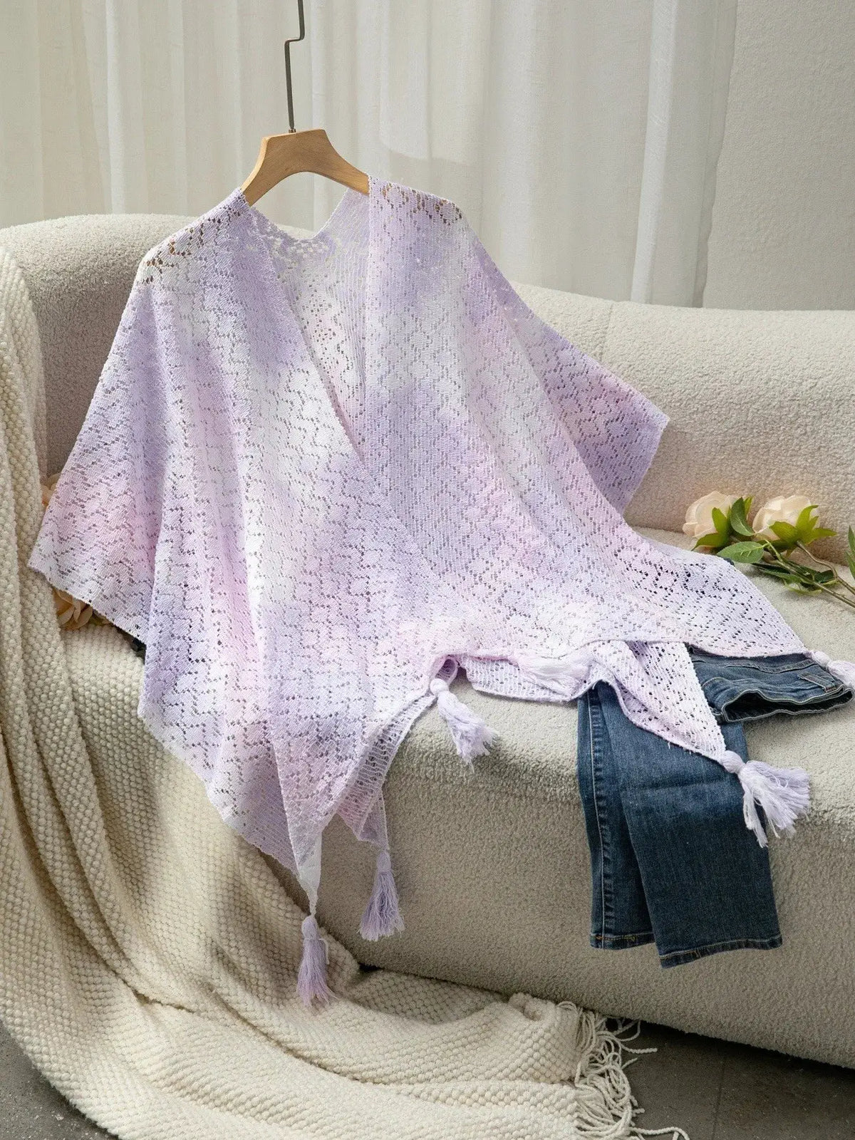 Trendsi lavender gradient openwork knit tassel beach cover-up on hanger with cream couch
