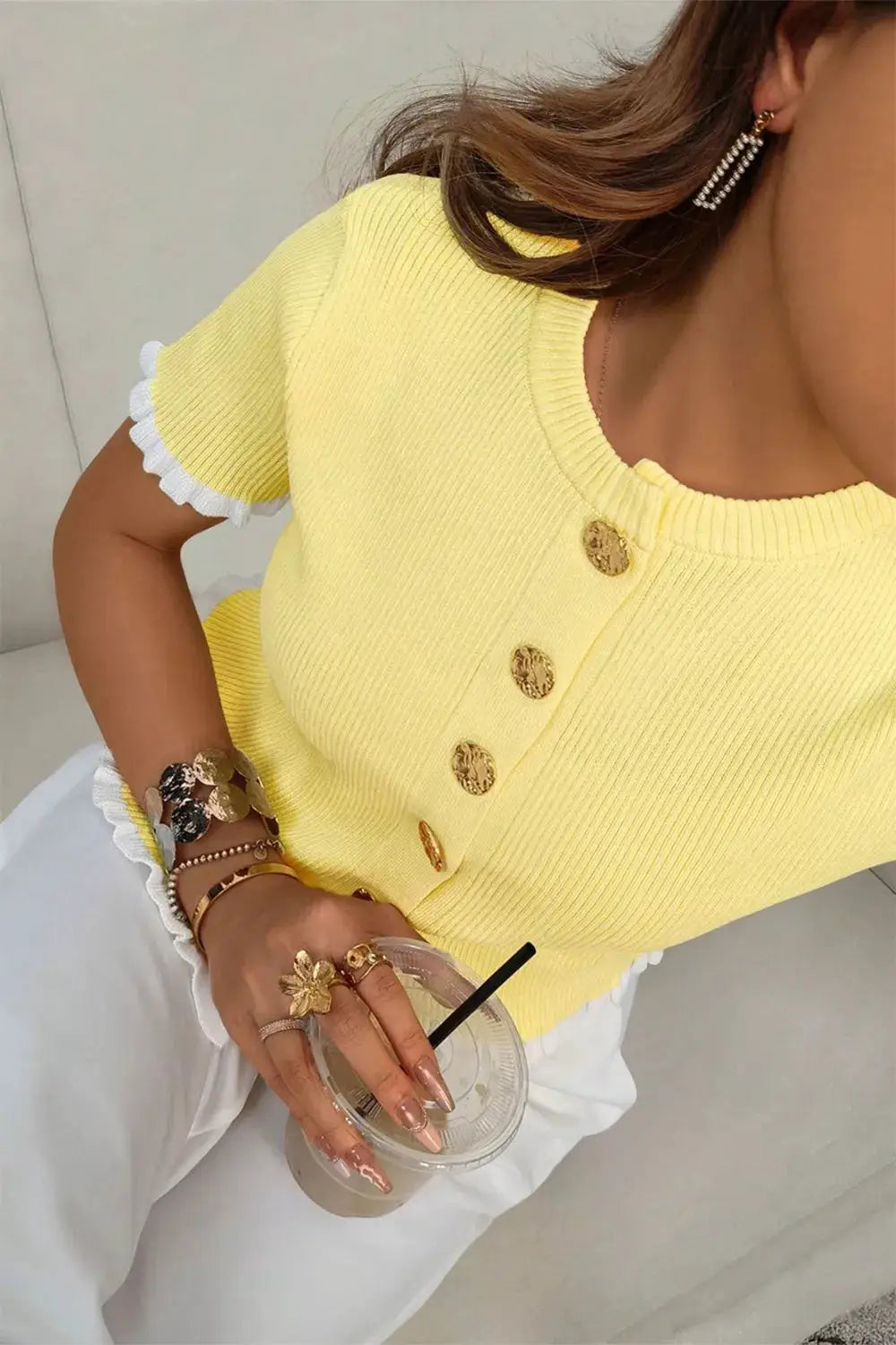 Short sleeve ribbed knit cardigan in yellow with white frill-edged sleeves and gold-tone buttons