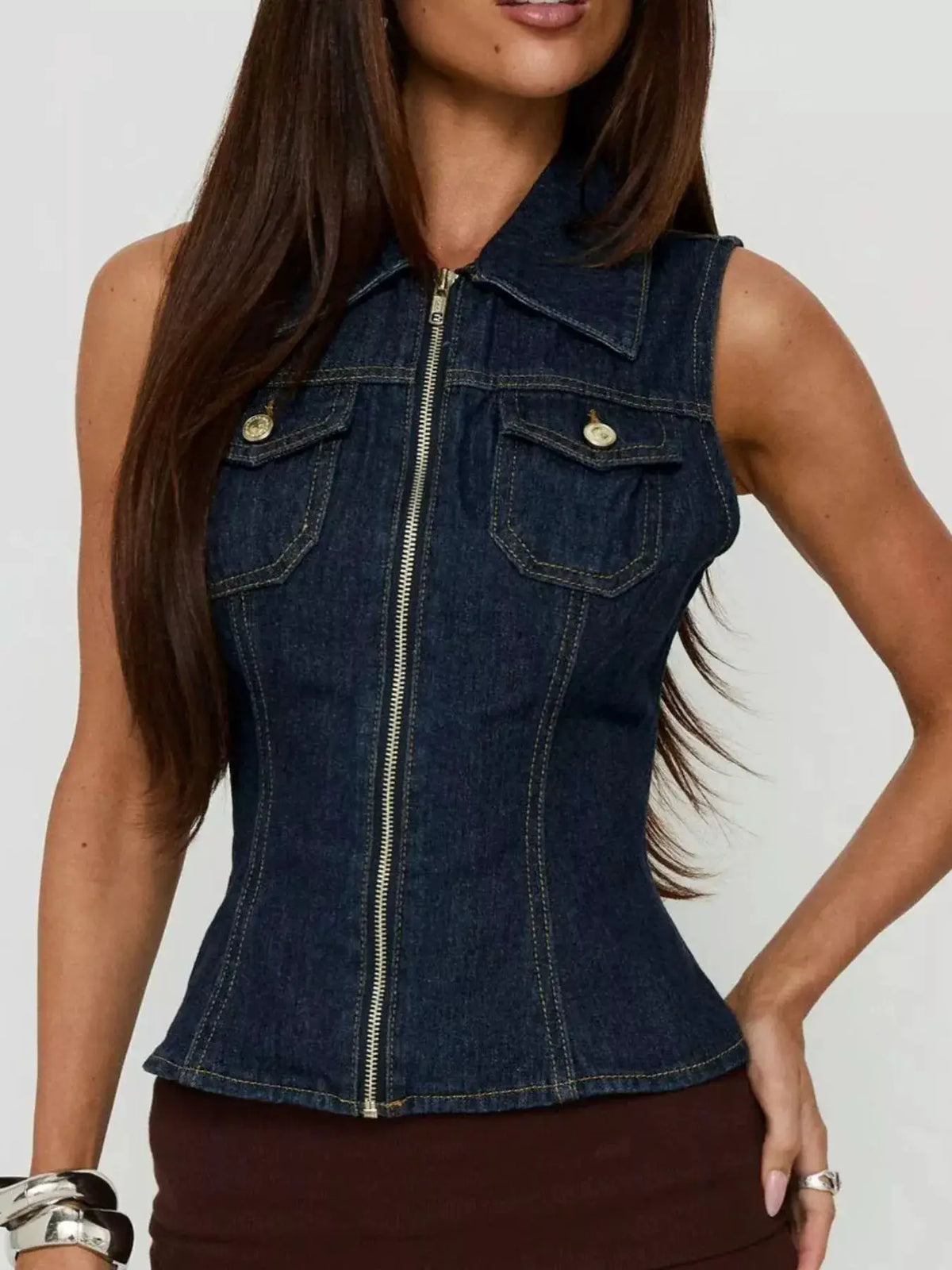 Sleeveless zip-up denim vest with collared neckline and chest pockets in dark indigo