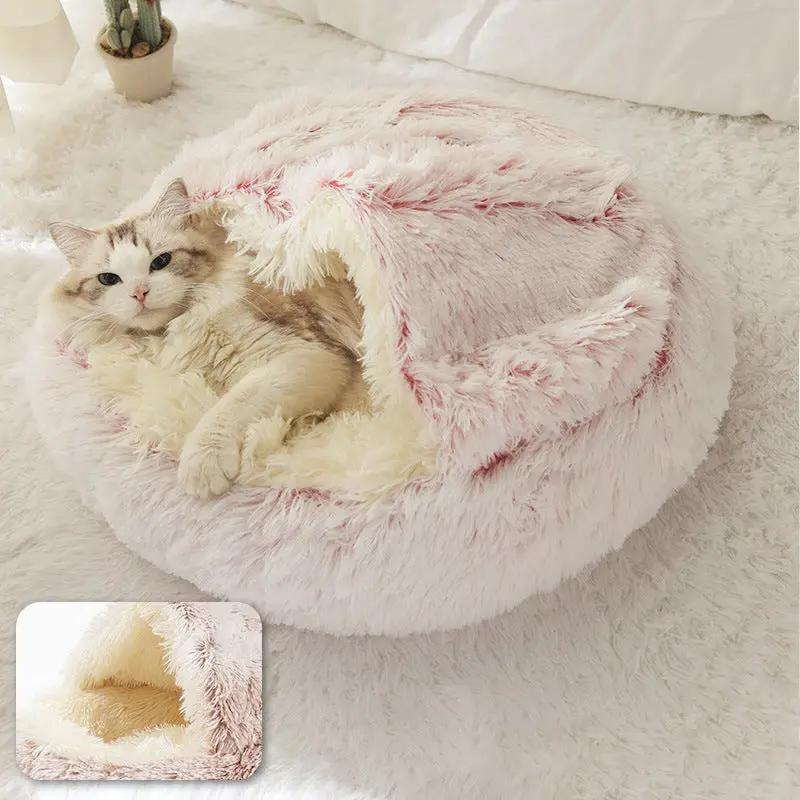 Plush shell pet nest in pale pink with fluffy interior, cat nestled inside