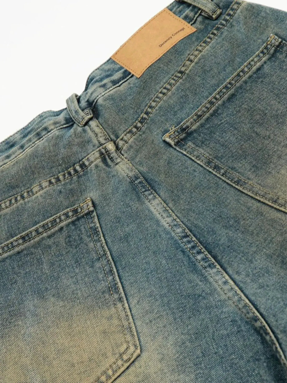 Men's distressed denim shorts with patchwork details, blue jean fabric, relaxed fit with back pockets.