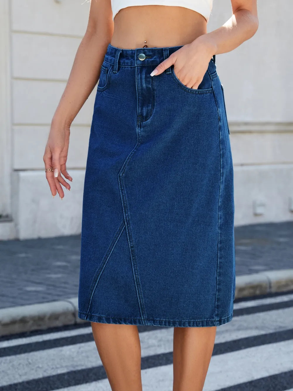 Slit-back midi denim skirt in blue with front pockets and belt loops