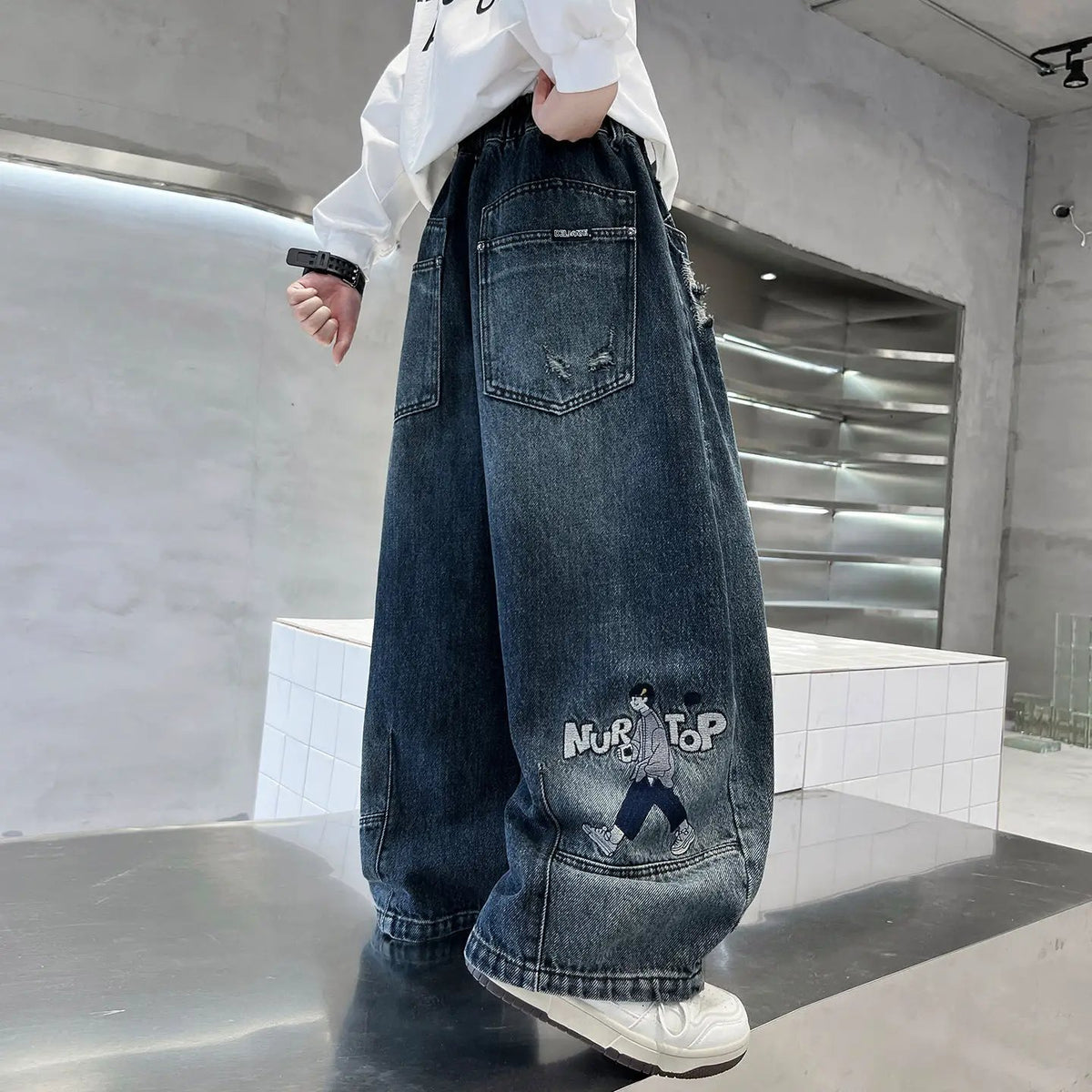 Trendy Boys Straight Wide Leg Denim Jeans, dark wash with distressed pockets and NURTOP graphic patch.