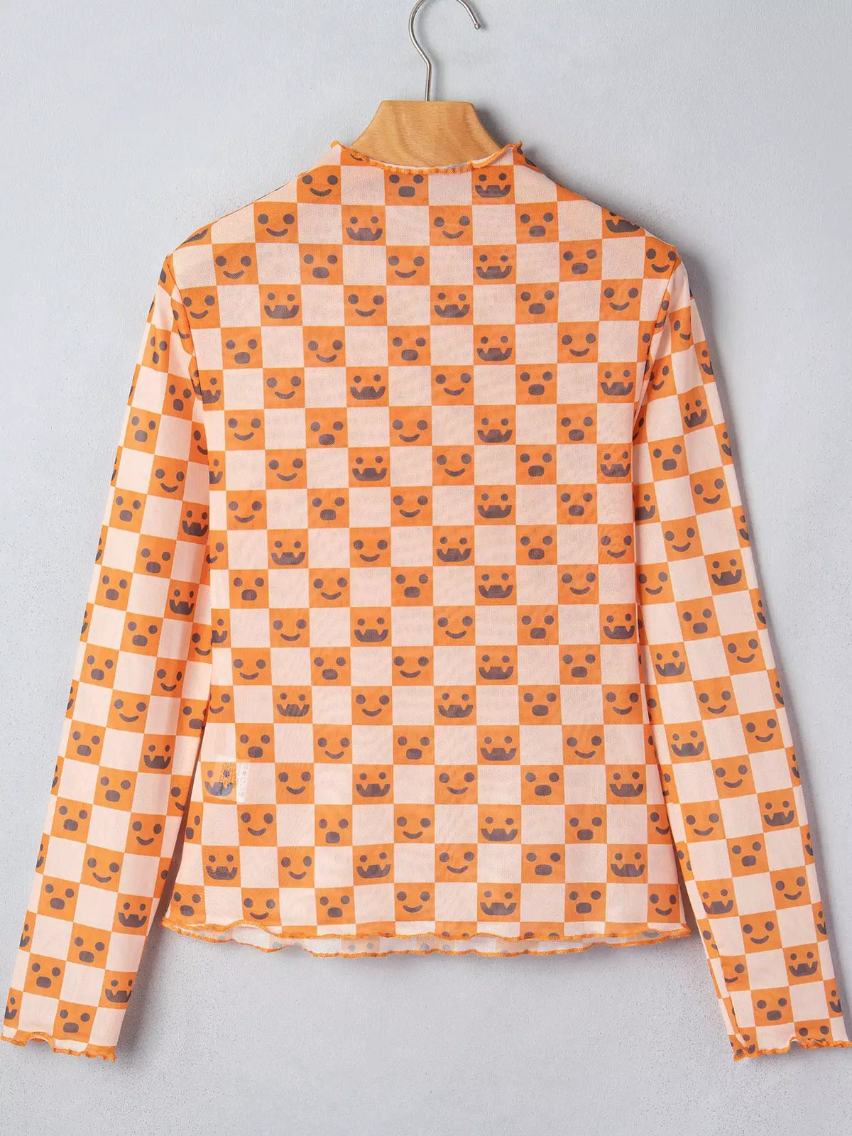 Abstract Halloween Pattern Long Sleeve Mock Neck Blouse in orange peach checker print by Trendsi