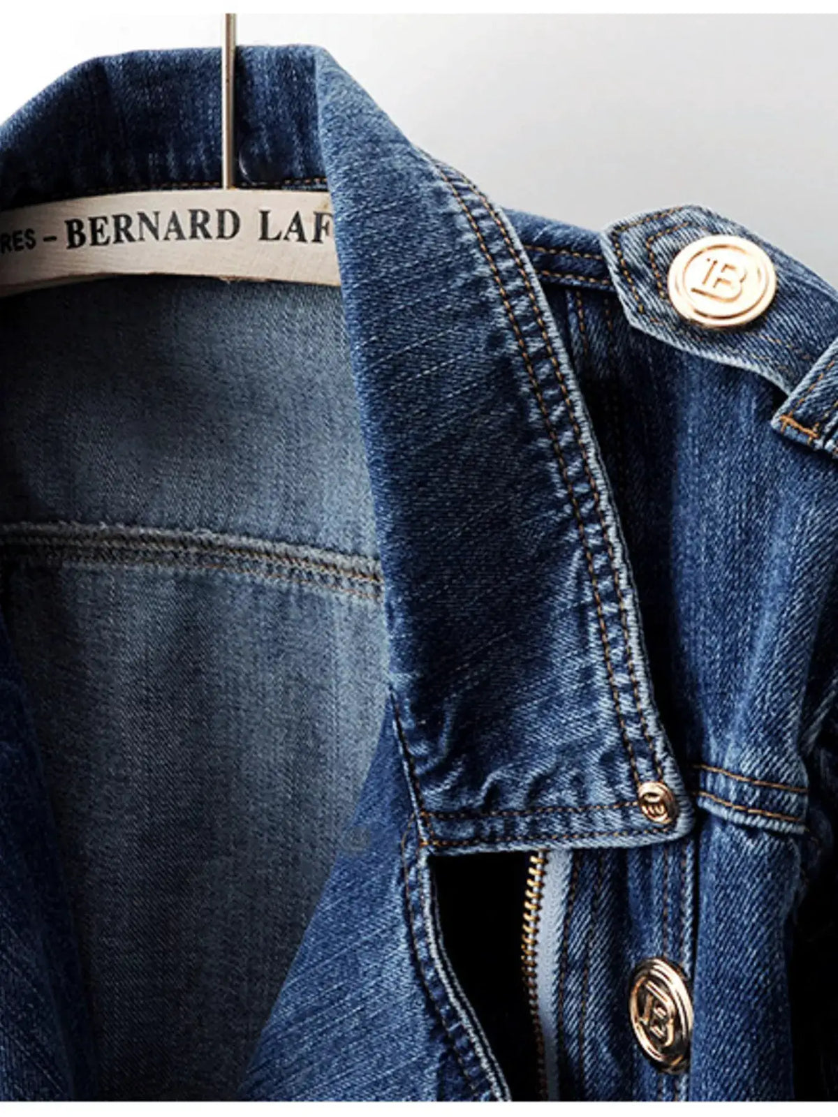 Denim jacket with asymmetrical zip front and belted waist, blue wash with gold-tone hardware