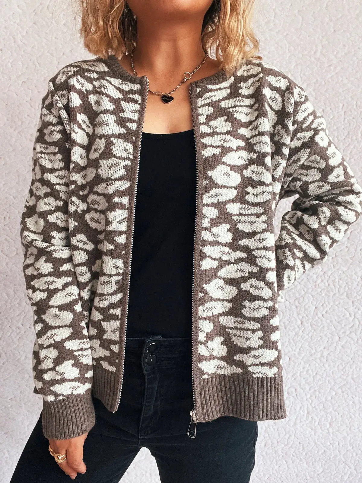 Zip-up long-sleeve cardigan in brown and beige camo knit; animal-print pattern with ribbed cuffs and hem.