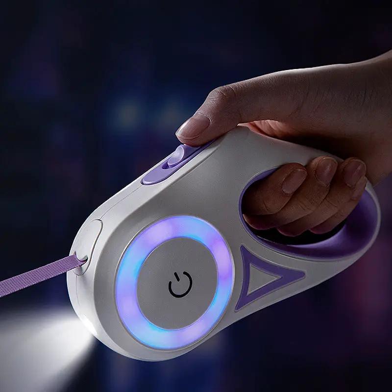 Retractable dog leash with LED spotlight, white and purple handheld device.
