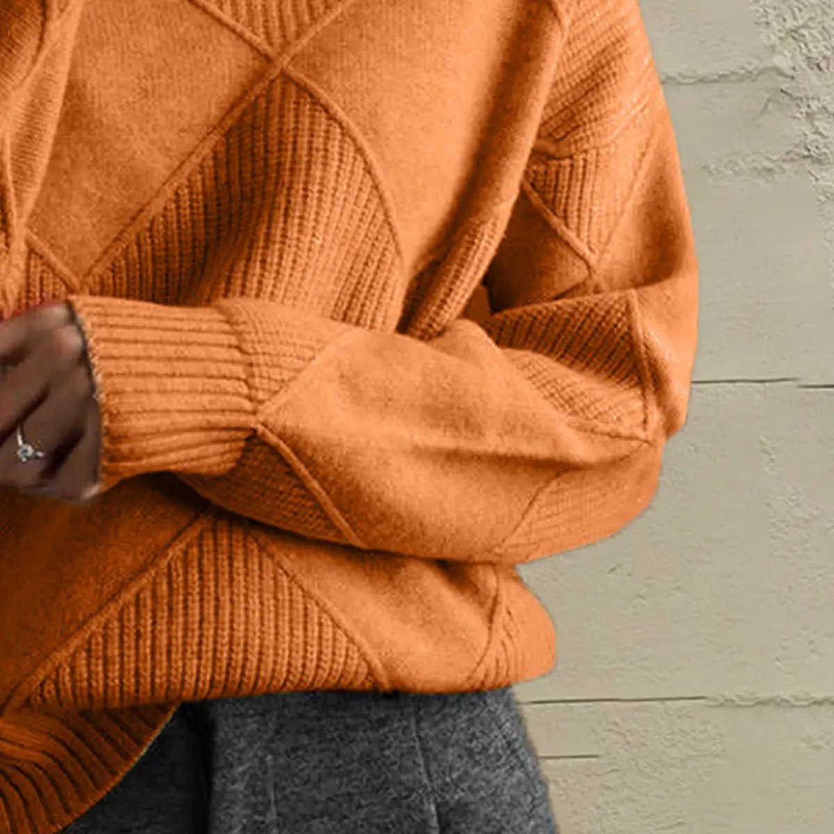 Geometric turtleneck long-sleeve sweater in orange stretch-knit.