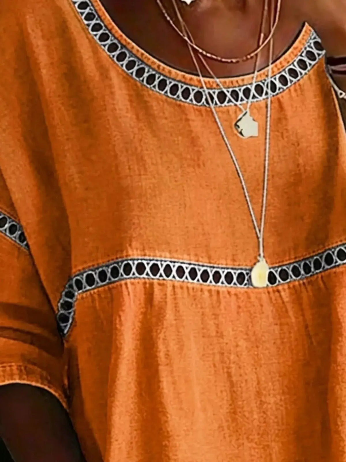 Plus-size orange hollow-out round-neck top with black-and-white lattice trim by Trendsi