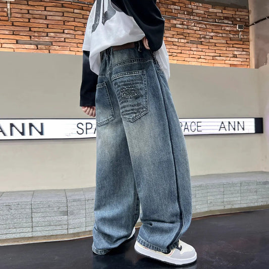 Boys casual loose-fit blue denim pants with a faded back-pocket patch