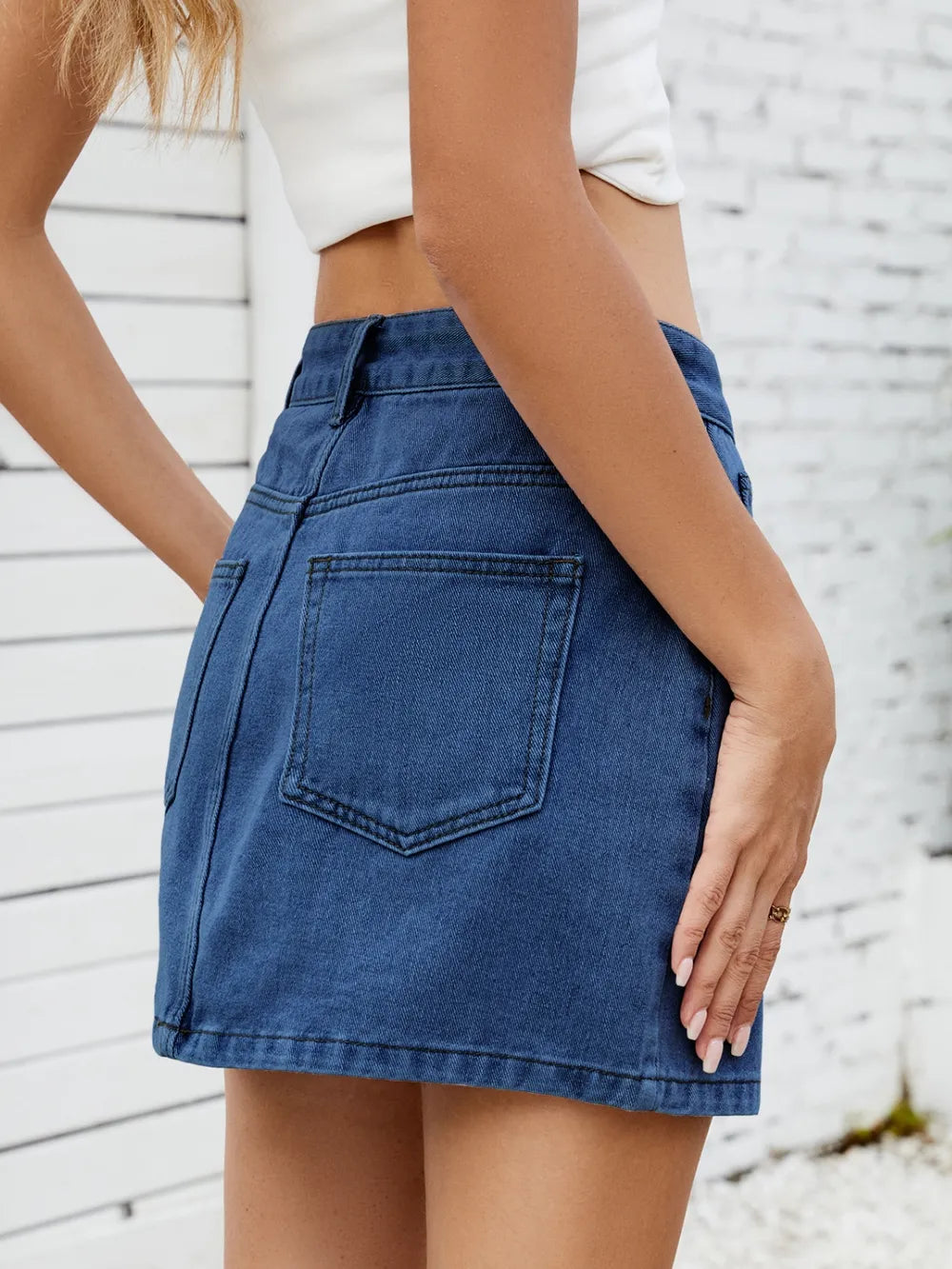 Solid mini denim skirt in blue with back pocket and clean hem