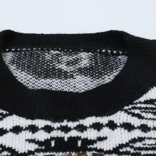 Women's knit pullover sweater by eprolo; black and white pattern with ribbed crew neck.