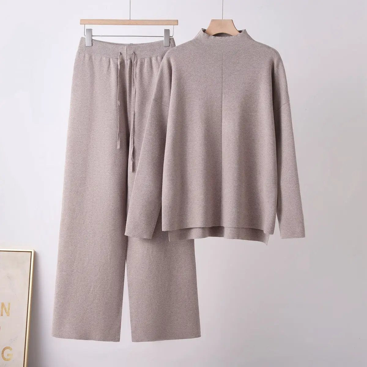 Soft knit two-piece set by eprolo in taupe with stand-up collar and long sleeves; top and pants.