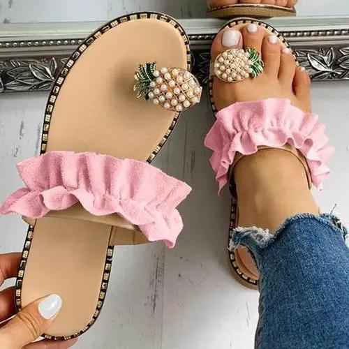 Pair of Pineapple Pearl Beach Slides for Women with pink ruffle straps and pineapple pearl toe decorations.