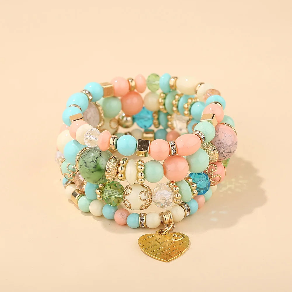 Boho crystal heart bracelet set by PrimeCanada.Store; pastel beads on elastic with gold spacers and a heart charm