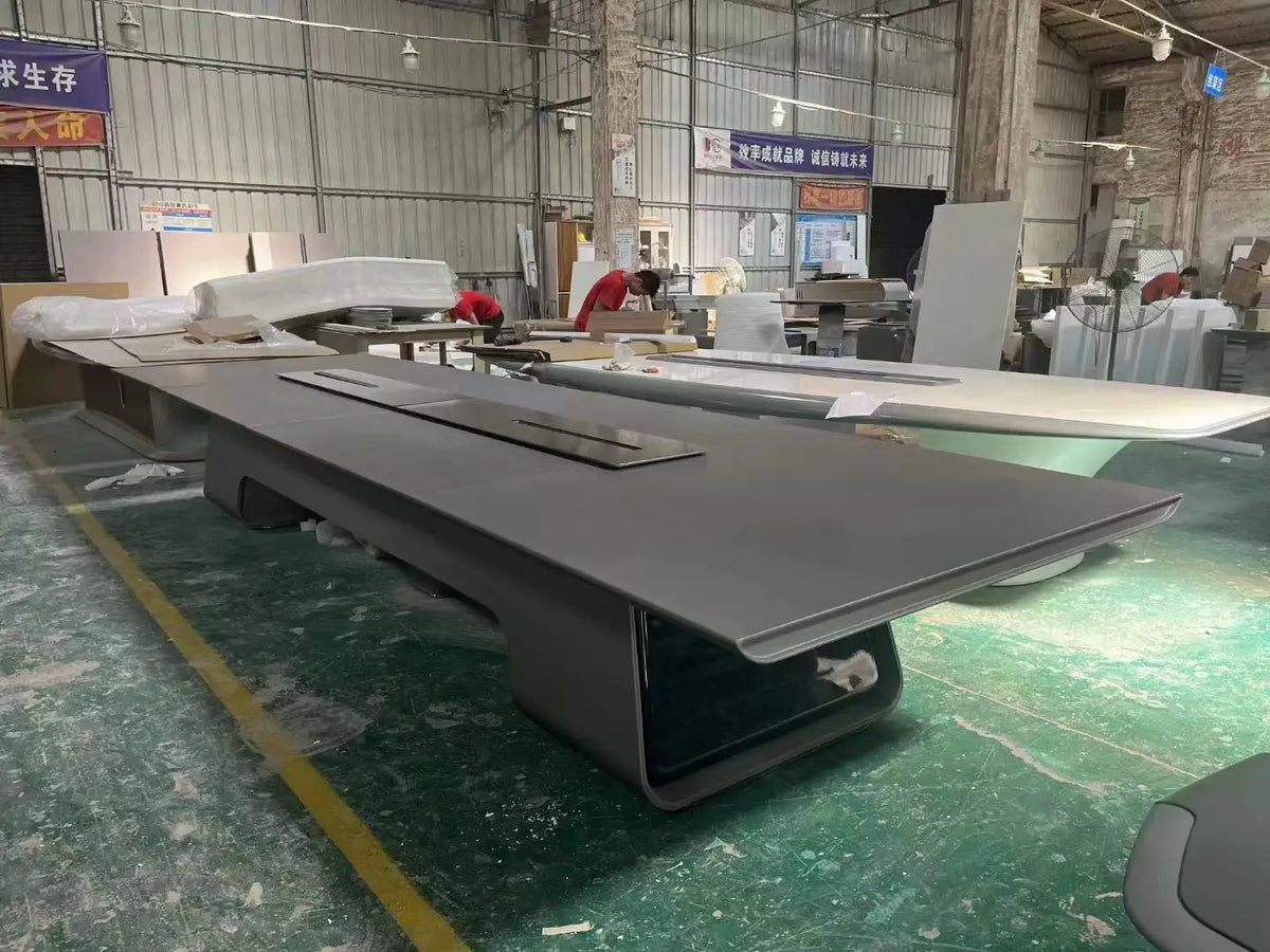 Large executive rectangular conference table in dark gray with a modern curved pedestal base