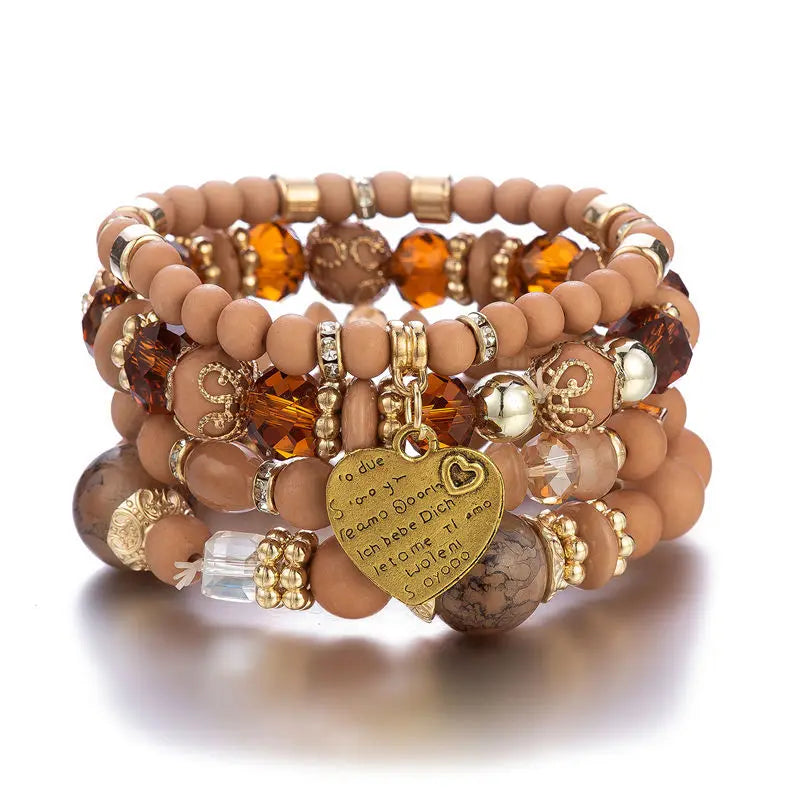 Boho crystal heart bracelet set; stackable elastic bracelets in peach tones with gold accents and heart charm
