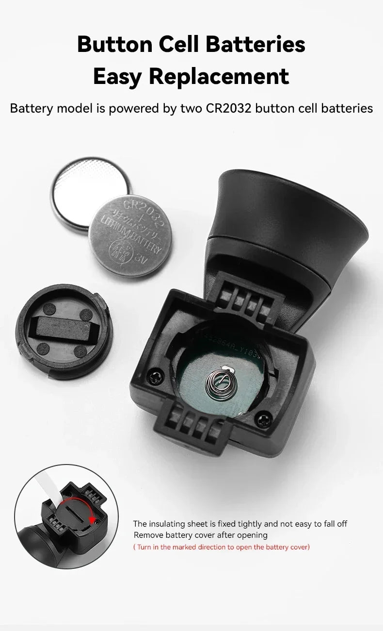 Black plastic bicycle horn bell with open battery compartment, showing two coin cell CR2032 batteries.