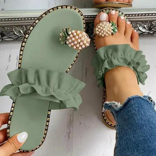 Pair of Pineapple Pearl Beach Slides, green flat sandals for women with ruffled straps and pineapple pearl accents