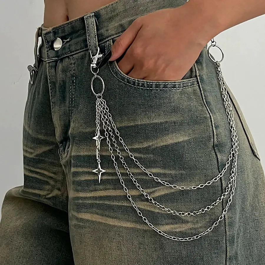 Waist chain with multiple silver metal chains and star charms, draped from belt loops for a punk hip jewelry look
