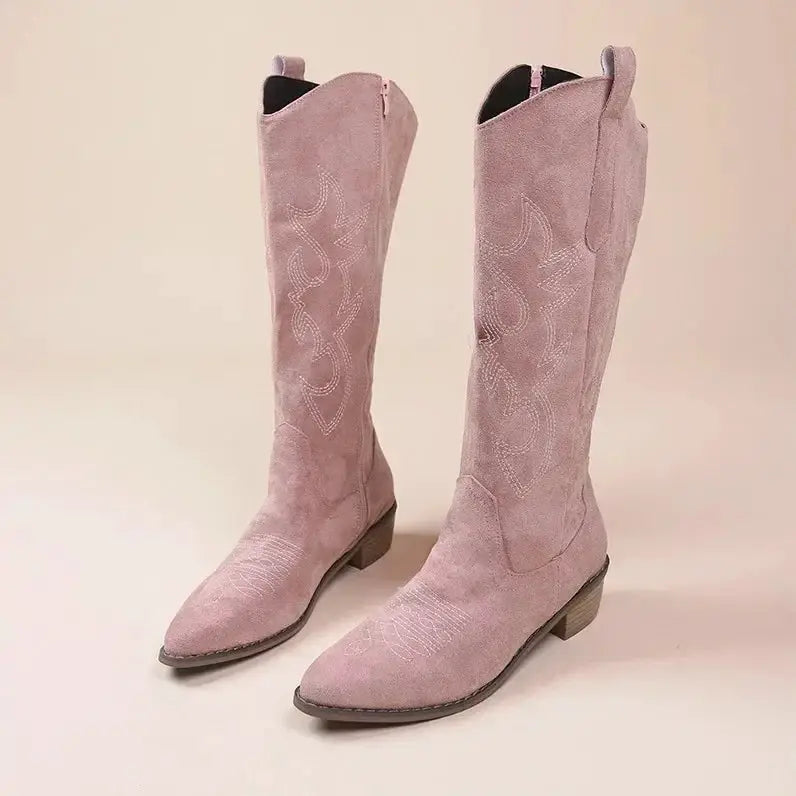Pair of women's pink suede embroidered cowboy boots, western style with a low stacked heel