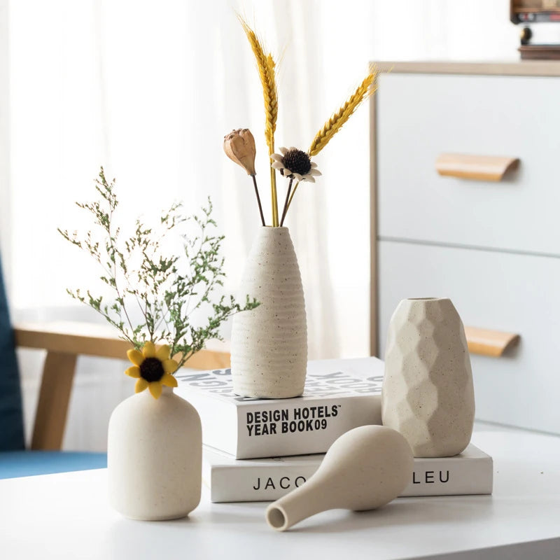 Ceramic vase set (4 vases) in cream tones with a textured tall vase, a faceted vase, and a small rounded vase.