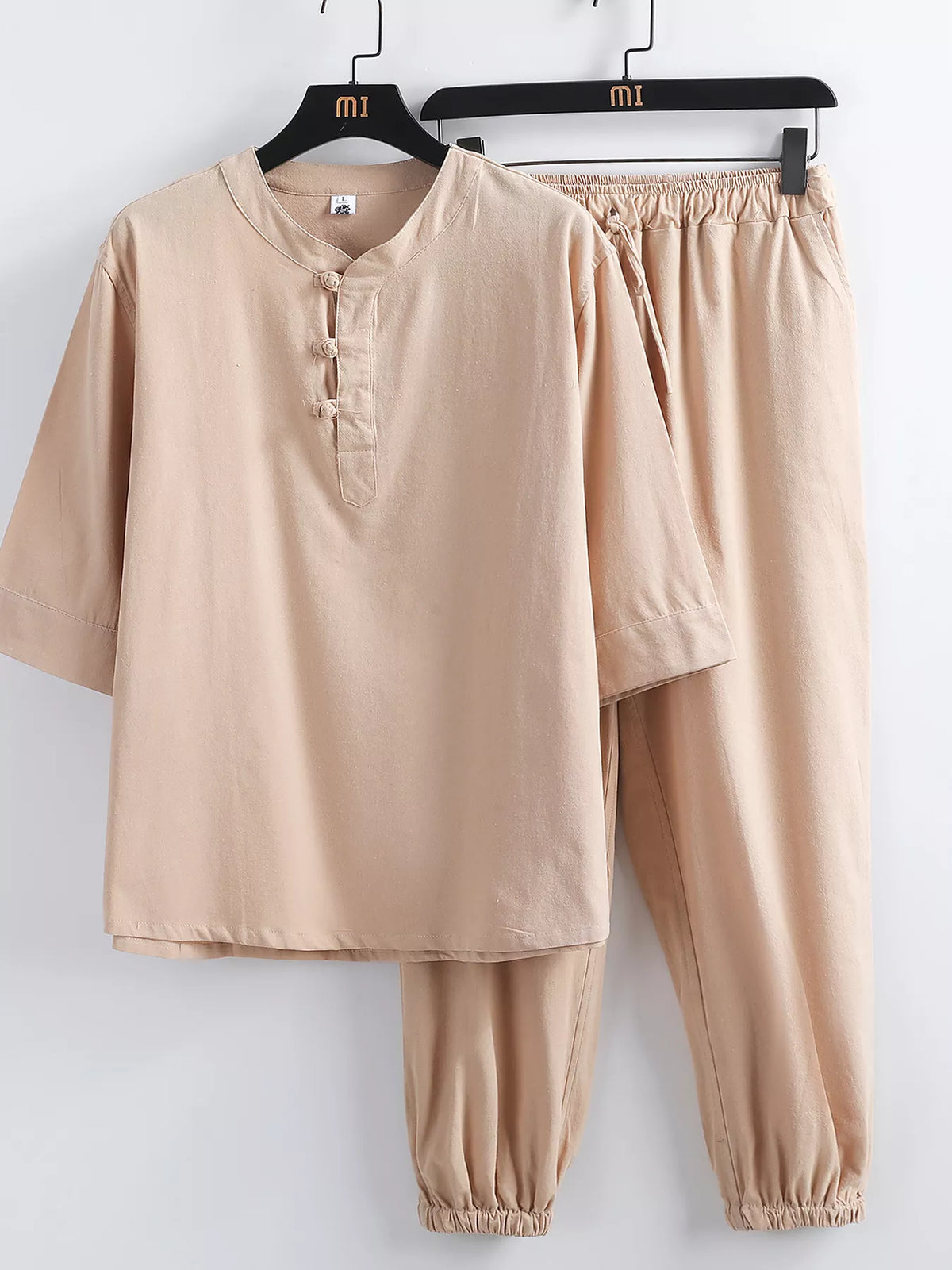 Trendsi men's plus-size 3/4 sleeve top and pants set in beige with knot buttons, drawstring waist, and elastic cuffs.
