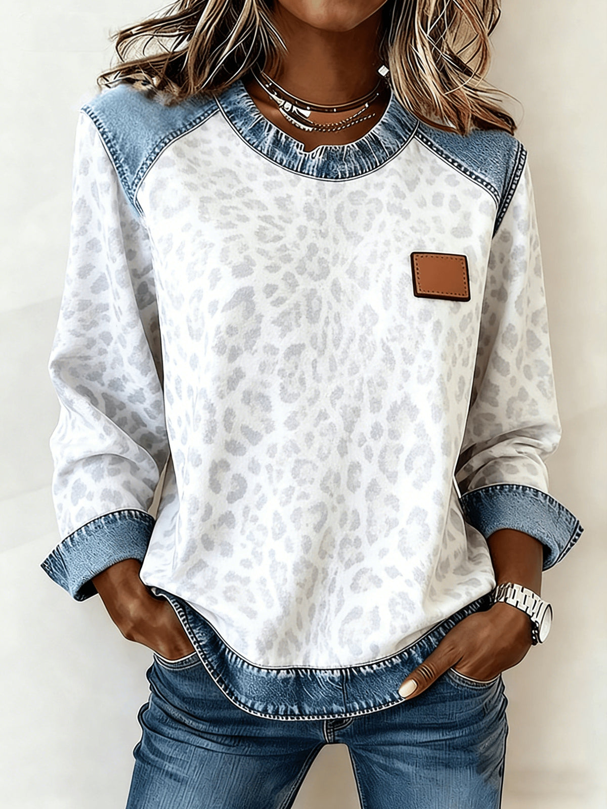 Women's Patchwork Denim Sweatshirt by AdTec; white leopard-print knit with blue denim patches.