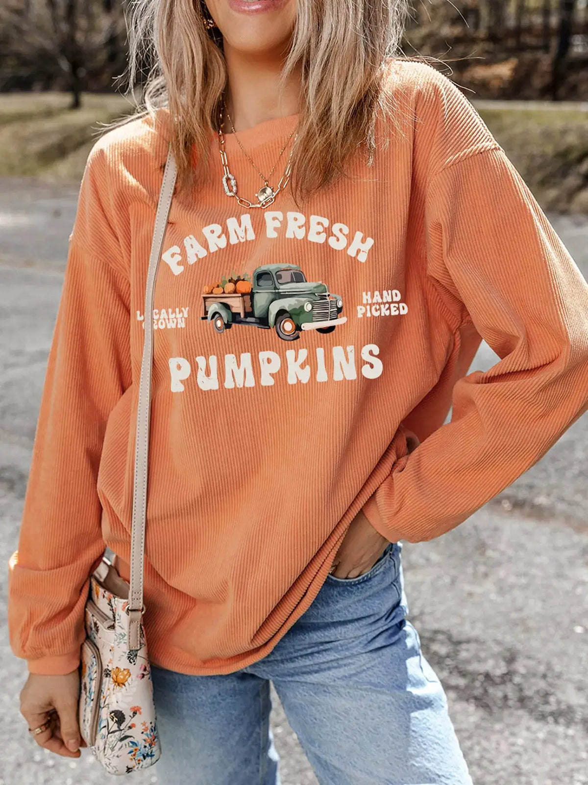 Corded ribbed orange sweatshirt with Farm Fresh Pumpkins graphic featuring a vintage green truck and pumpkins.